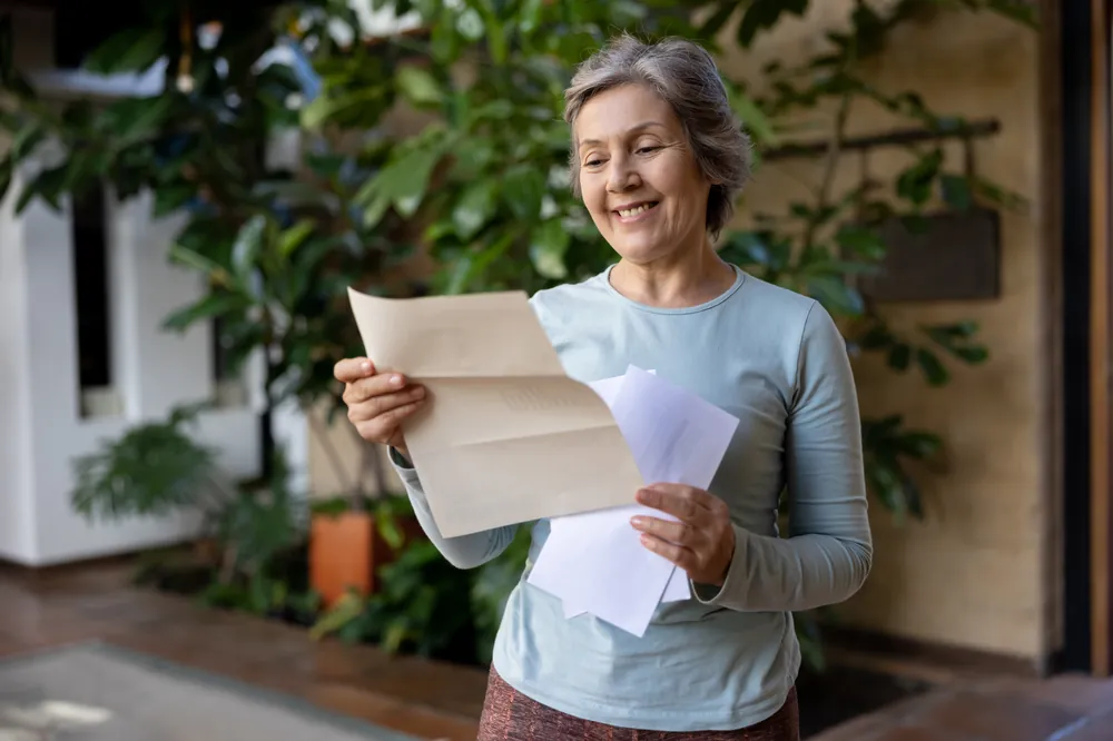 A Northern Rivers homeowner reading her electricity bill at home